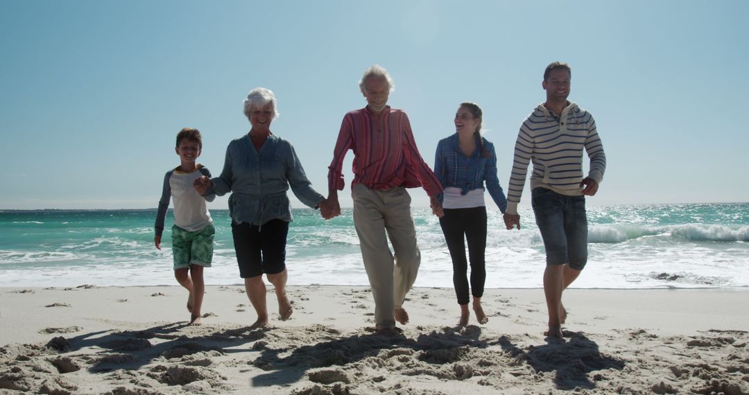 Happy Multigenerational Family Walking on Sunny Beach - Free Images, Stock Photos and Pictures on Pikwizard.com