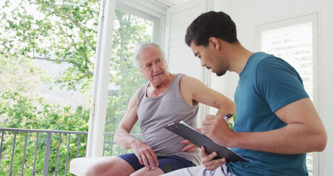 Young Caregiver Assisting Senior Man at Home in Bright Room - Free Images, Stock Photos and Pictures on Pikwizard.com