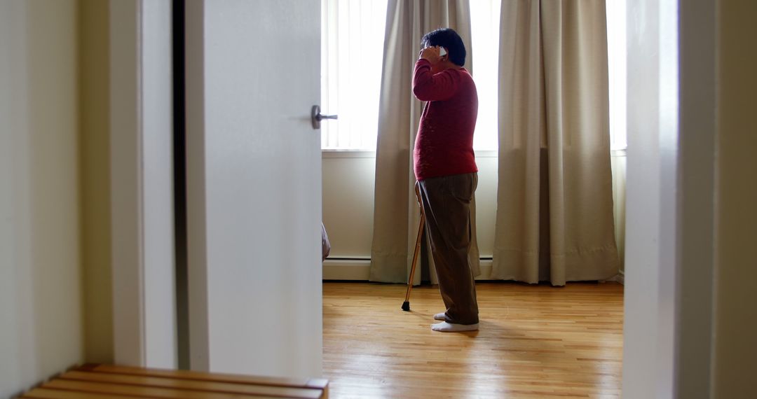 Blind Man Standing in Sunlit Room Using White Cane - Free Images, Stock Photos and Pictures on Pikwizard.com