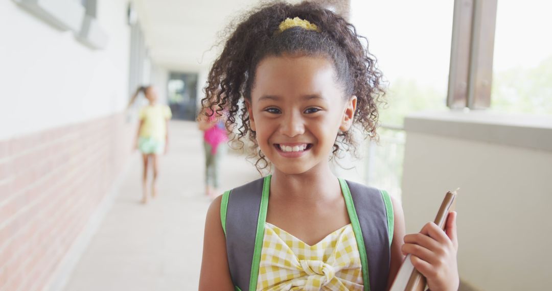 Smiling Young Girl with Backpack and Notebook in School Hallway - Free Images, Stock Photos and Pictures on Pikwizard.com