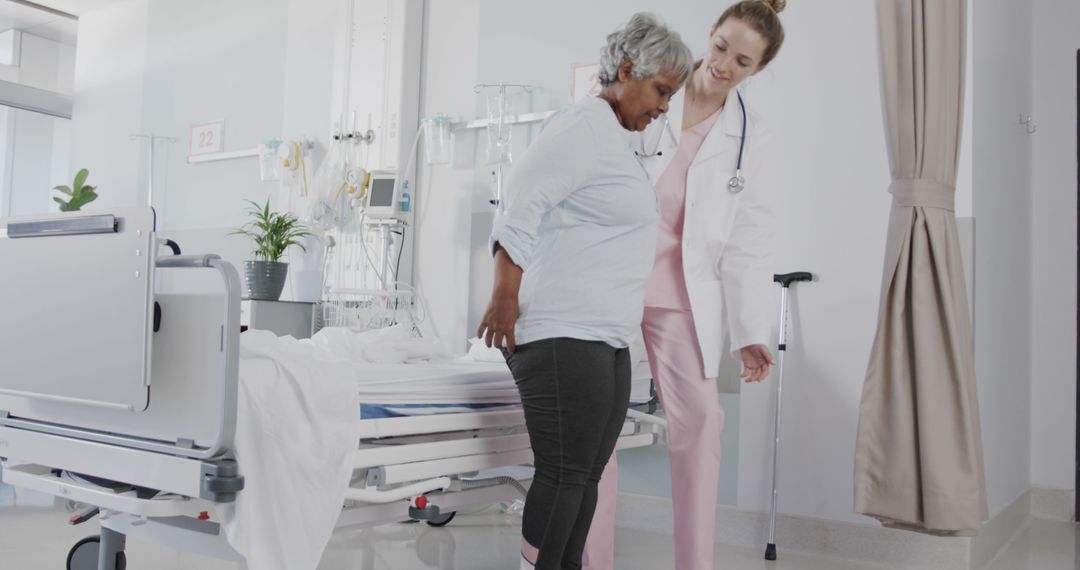 Healthcare Worker Assisting Senior Patient in Hospital Room - Free Images, Stock Photos and Pictures on Pikwizard.com