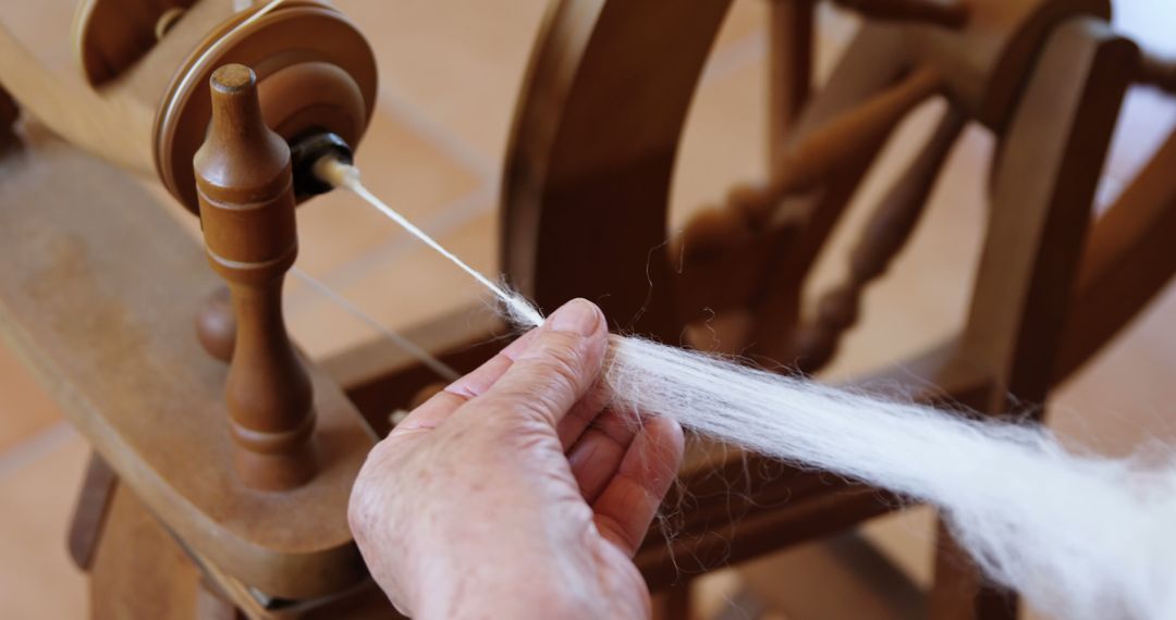 Close-up of Hands Spinning Yarn on Spinning Wheel - Free Images, Stock Photos and Pictures on Pikwizard.com