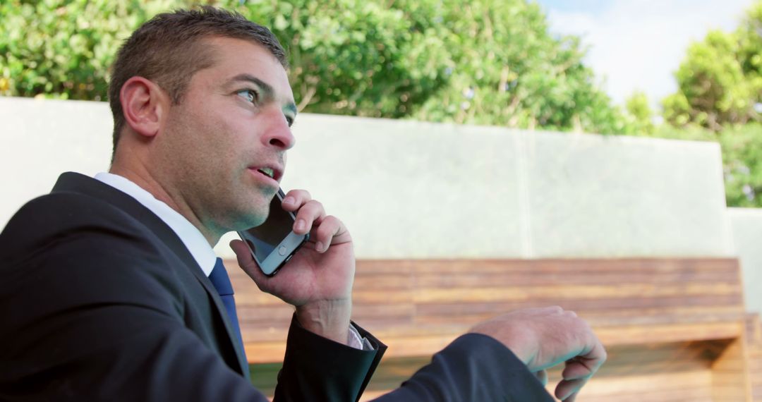 Businessman in Suit Having Phone Call Outdoors - Free Images, Stock Photos and Pictures on Pikwizard.com