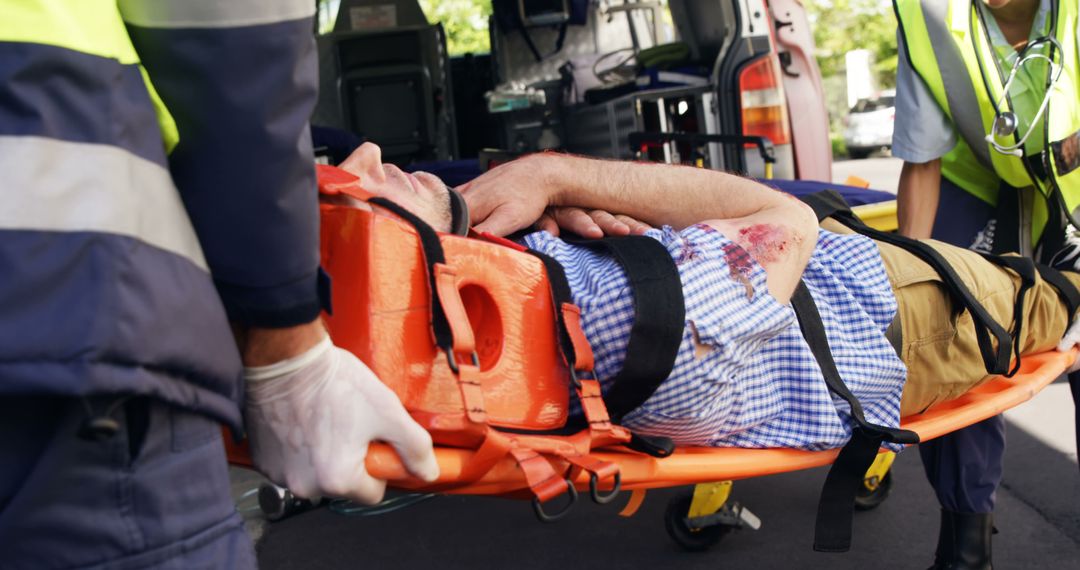 Paramedics Transporting Injured Man on Stretcher Into Ambulance - Free Images, Stock Photos and Pictures on Pikwizard.com