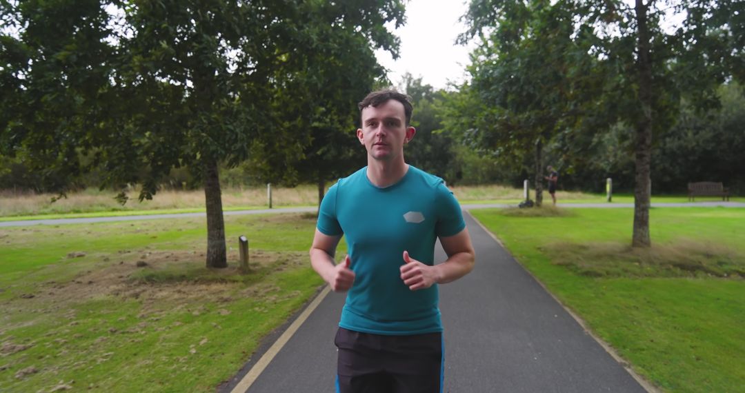 Man Jogging on Park Path in Athletic Gear