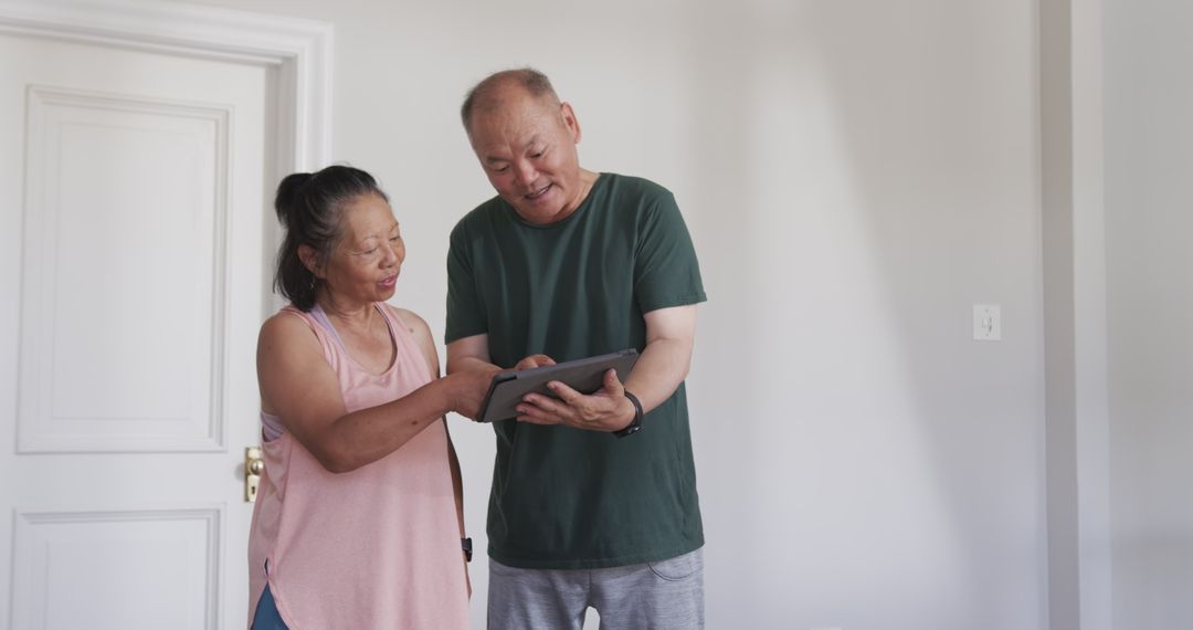 Elderly Couple Enjoying Time with Tablet at Home