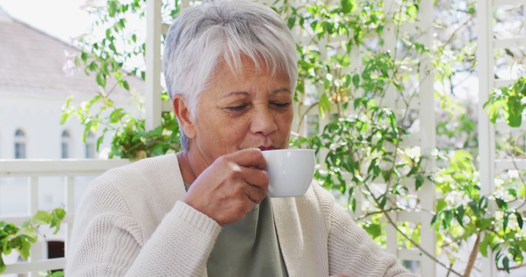 Senior Woman Enjoying Tea on Garden Patio - Free Images, Stock Photos and Pictures on Pikwizard.com