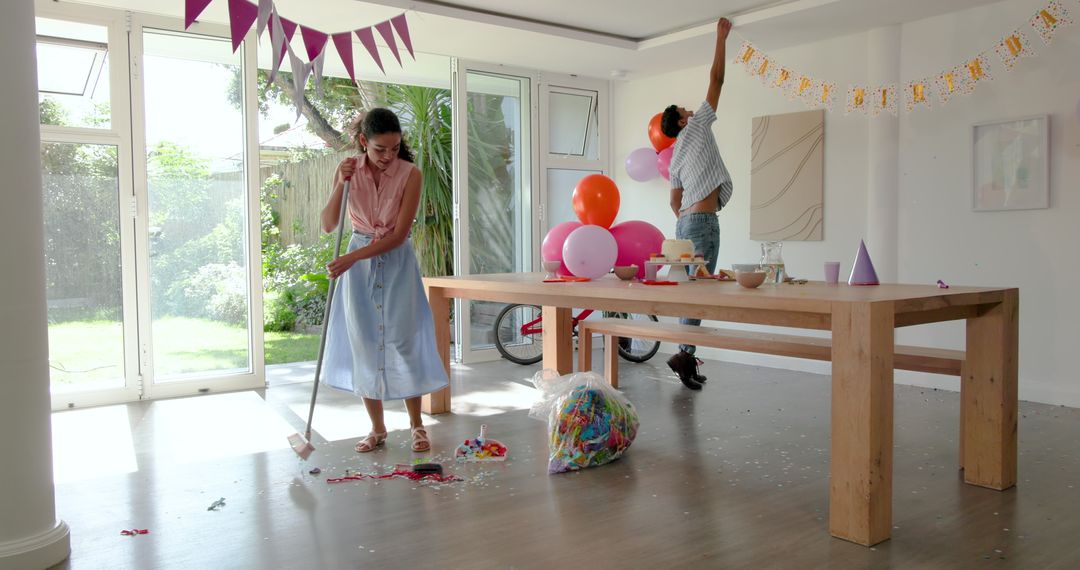 Family Cleaning Up Birthday Party with Teamwork Inside Home