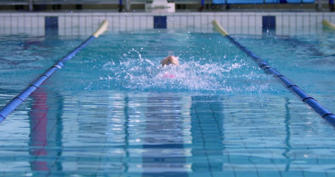 Person Swimming in Indoor Pool with Distinct Lanes - Free Images, Stock Photos and Pictures on Pikwizard.com