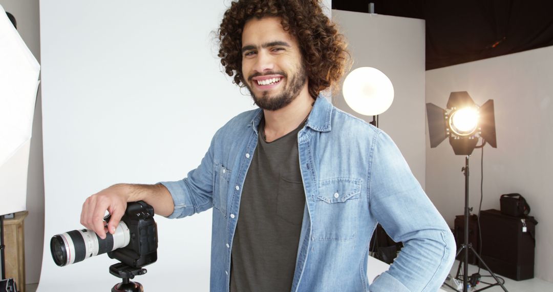 Smiling Photographer in Studio with Professional Camera Equipment - Free Images, Stock Photos and Pictures on Pikwizard.com