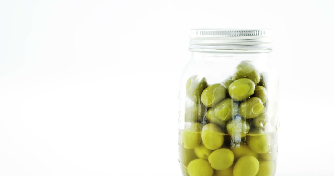 Green Olives in Glass Jar Against White Background - Free Images, Stock Photos and Pictures on Pikwizard.com