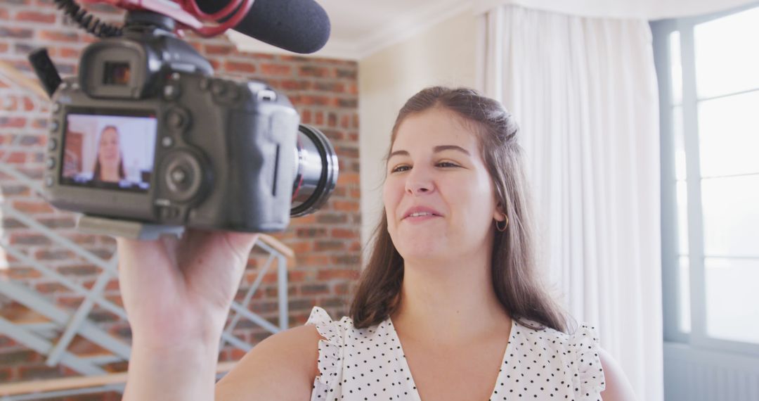 Female Vlogger Recording Video Indoors with a Professional Camera - Free Images, Stock Photos and Pictures on Pikwizard.com