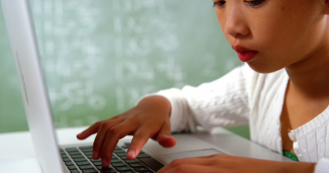 Young Student Using Laptop in Classroom