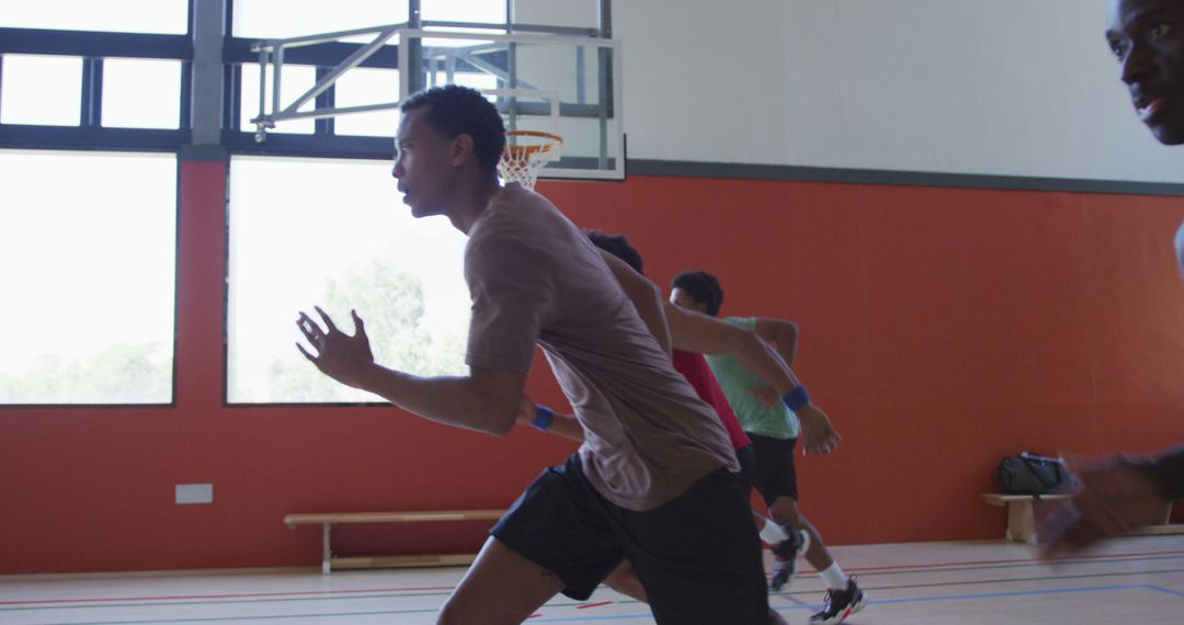 Young athletes running in an indoor basketball court - Free Images, Stock Photos and Pictures on Pikwizard.com