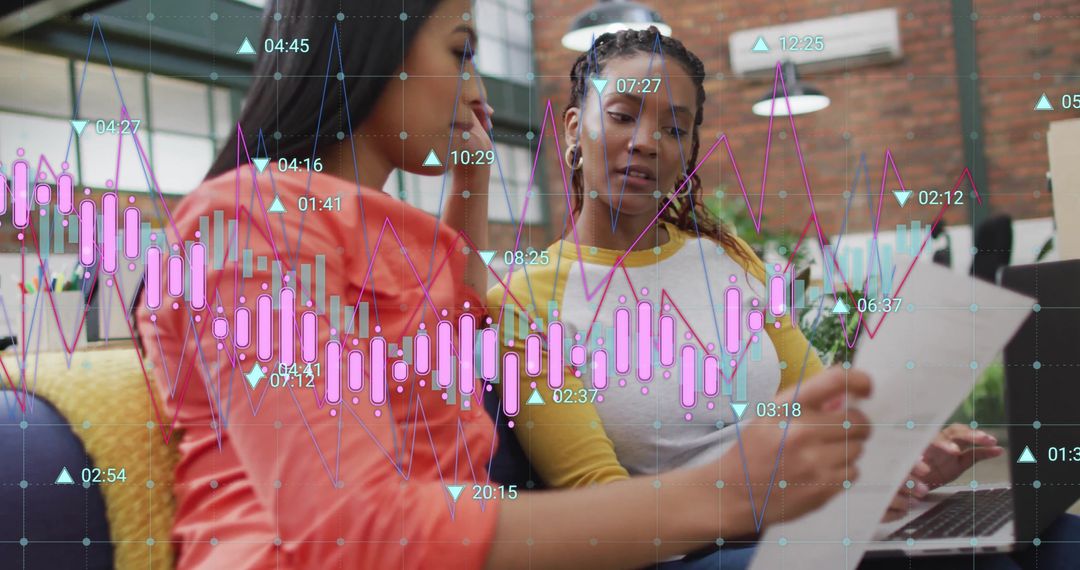 Diverse Businesswomen Analyzing Data with Digital Graphs