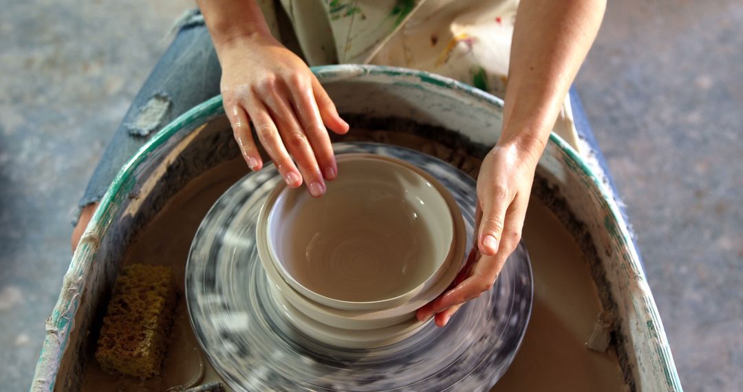 Hands Creating Pottery on Spinning Wheel in Ceramic Studio - Free Images, Stock Photos and Pictures on Pikwizard.com