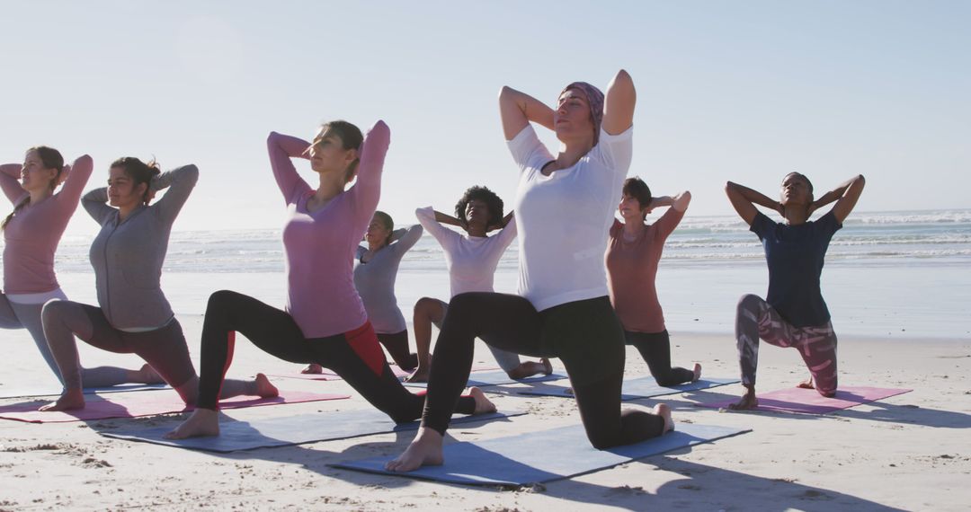 Diverse group practicing yoga on beach at sunrise - Free Images, Stock Photos and Pictures on Pikwizard.com