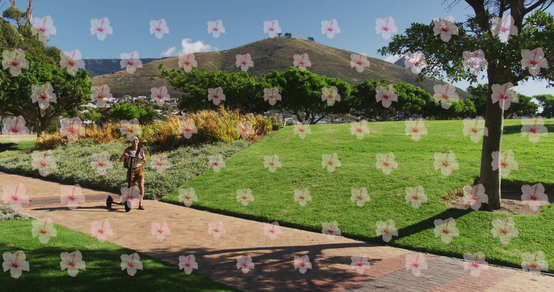 Woman Walking with Scooter in Park with Floral Overlay Design