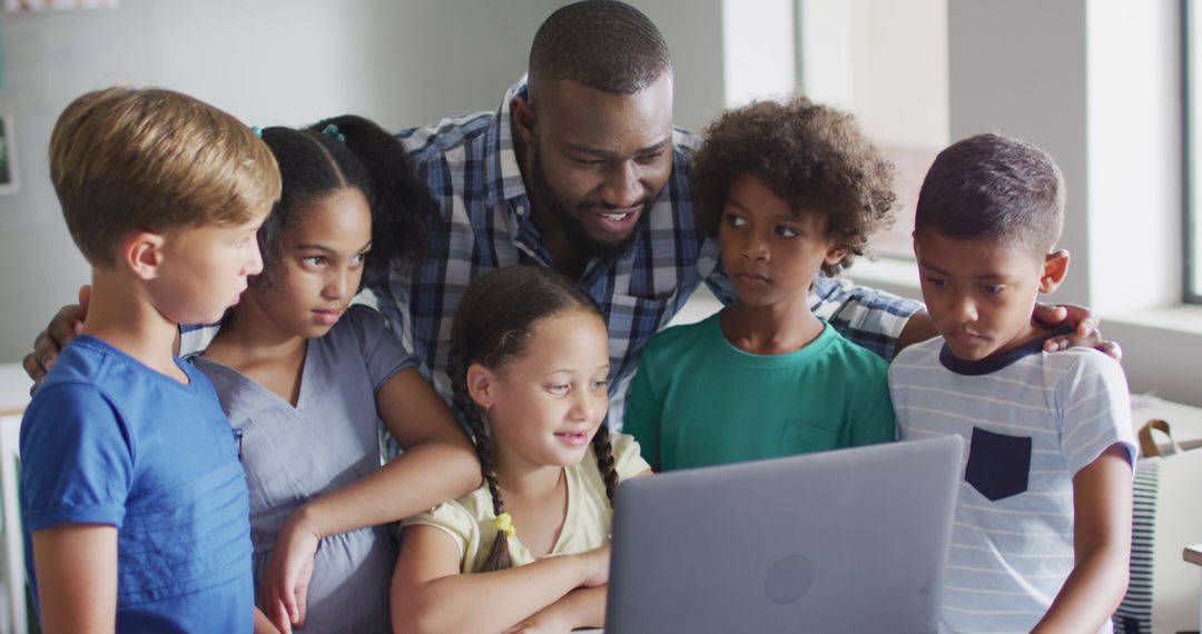 Image of happy african american male teacher and class of diverse pupils working on laptop - Free Images, Stock Photos and Pictures on Pikwizard.com