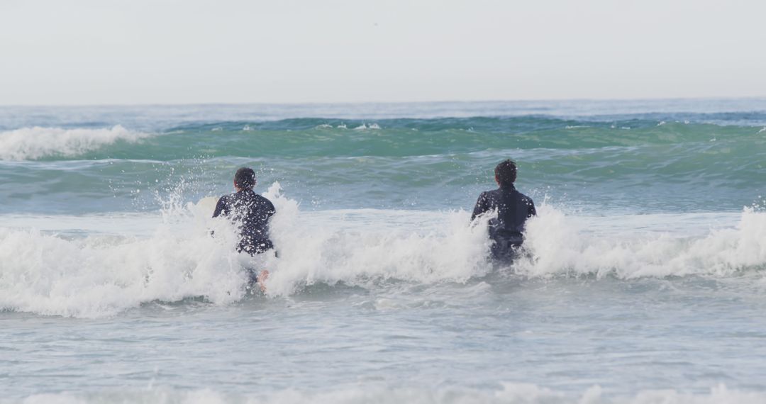 Father and Son Surfing Together in Ocean Waves - Free Images, Stock Photos and Pictures on Pikwizard.com