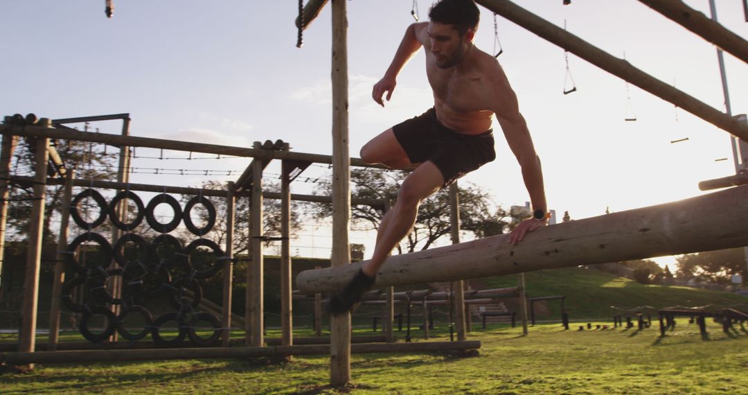 Athletic Man Conquering Outdoor Obstacle Course at Sunset - Free Images, Stock Photos and Pictures on Pikwizard.com