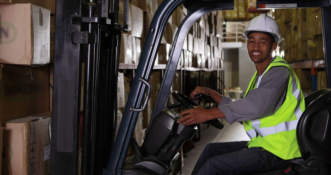 Smiling Warehouse Worker Operating Forklift in Storage Facility - Free Images, Stock Photos and Pictures on Pikwizard.com