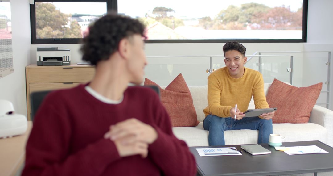 Hispanic Male Colleagues Collaborating in Modern Workspace