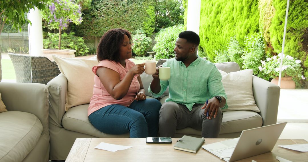 Mature Couple Making a Toast with Coffee on Relaxing Patio