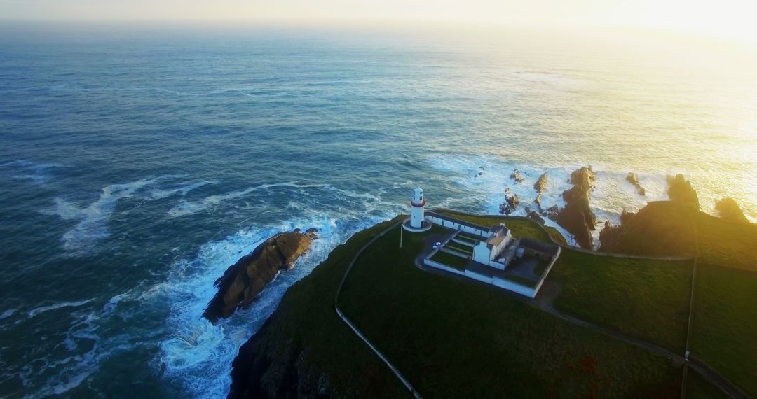 Aerial View of Oceanfront Lighthouse at Sunset - Free Images, Stock Photos and Pictures on Pikwizard.com