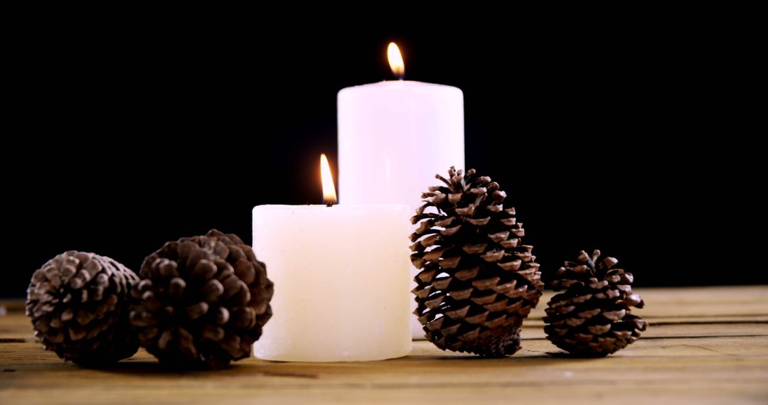 Candles and Pine Cones on Wooden Table Creating Cozy Winter Atmosphere - Free Images, Stock Photos and Pictures on Pikwizard.com