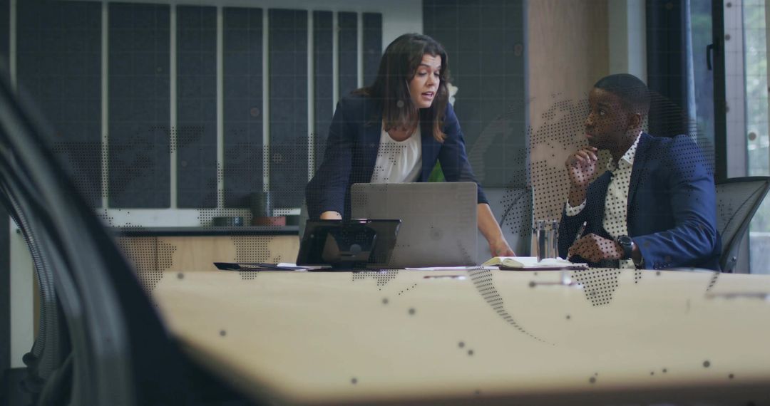 Colleagues Collaborating Over Conference Table with Digital Devices in Modern Office