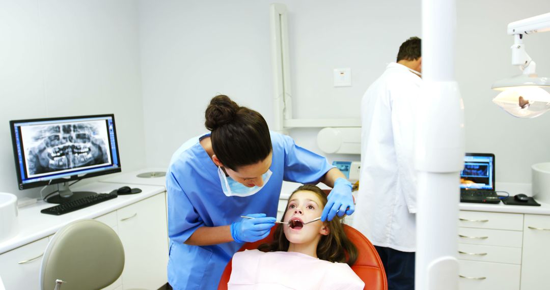 Dentist Examining Young Patient in Dental Clinic - Free Images, Stock Photos and Pictures on Pikwizard.com