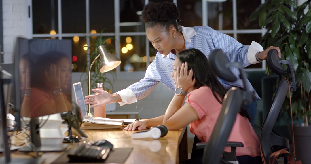 Colleagues Collaborating Late at Night in Modern Office Environment