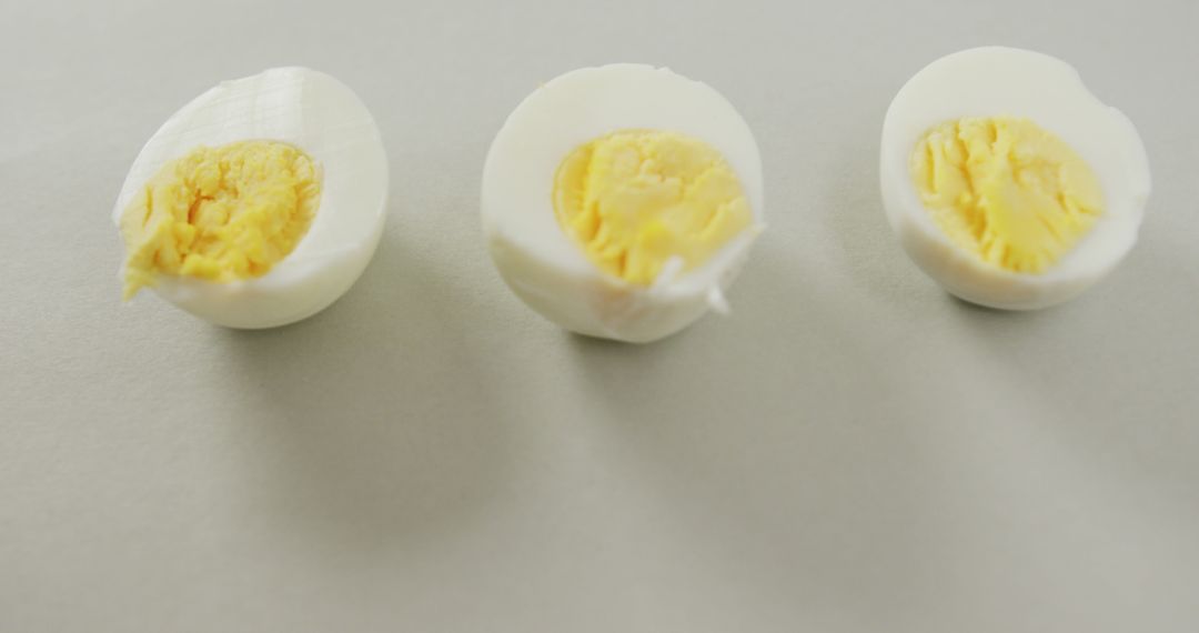 Three Halved Boiled Eggs on Light Background - Free Images, Stock Photos and Pictures on Pikwizard.com