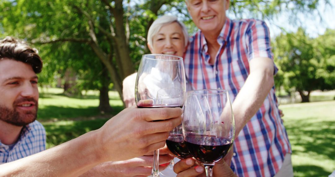 Happy Family Toasting with Red Wine in Park Outdoors - Free Images, Stock Photos and Pictures on Pikwizard.com