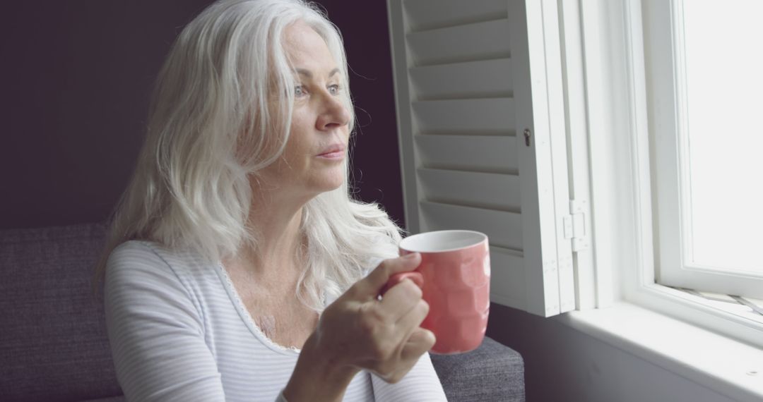 Elderly Woman Relaxing With Coffee By Window - Free Images, Stock Photos and Pictures on Pikwizard.com