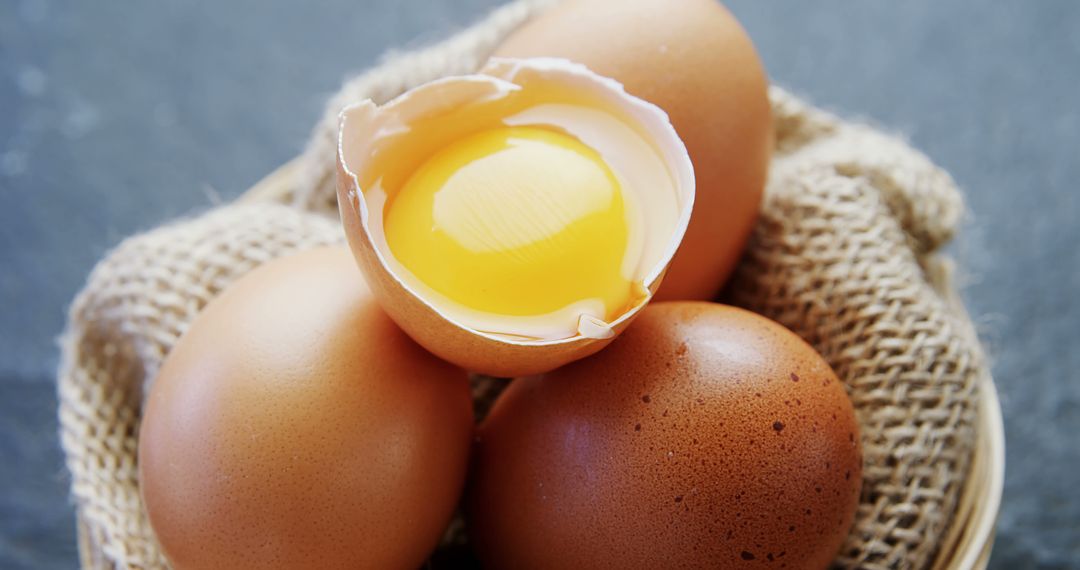 Fresh Brown Eggs in Rustic Basket with Cracked Egg Yolk - Free Images, Stock Photos and Pictures on Pikwizard.com