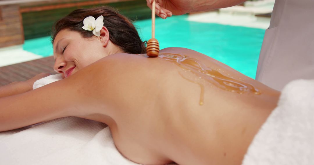 Woman Receiving Relaxing Honey Massage by Pool - Free Images, Stock Photos and Pictures on Pikwizard.com