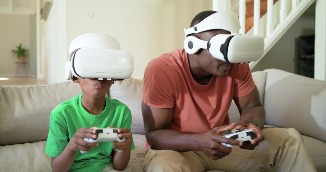 African American Father and Son Playing VR Games on Couch at Home, Virtual Reality Fun