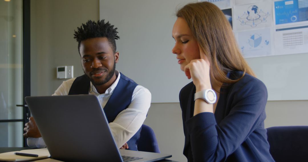 Diverse Colleagues Collaborating on Business Project with Laptop