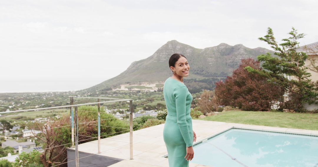 Woman in Green Dress Smiling by Mountain View Terrace - Free Images, Stock Photos and Pictures on Pikwizard.com