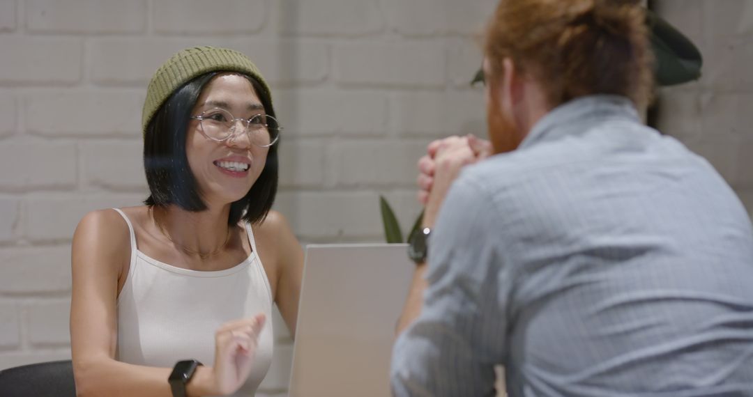 Smiling Colleagues Engaging in Friendly Office Discussion