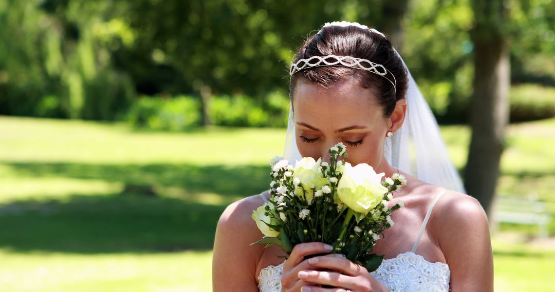 Bride Smelling Bouquet on Sunny Day - Free Images, Stock Photos and Pictures on Pikwizard.com