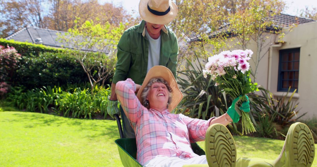 Senior Couple Enjoying Gardening Together with Wheelbarrow Ride - Free Images, Stock Photos and Pictures on Pikwizard.com