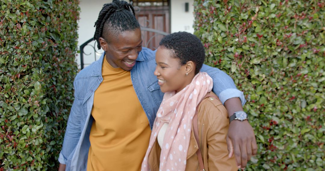 Happy african american couple embracing outside a house - Free Images, Stock Photos and Pictures on Pikwizard.com