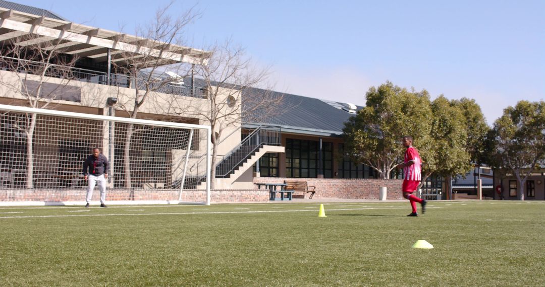 Boys practicing soccer dribbling skills on school field