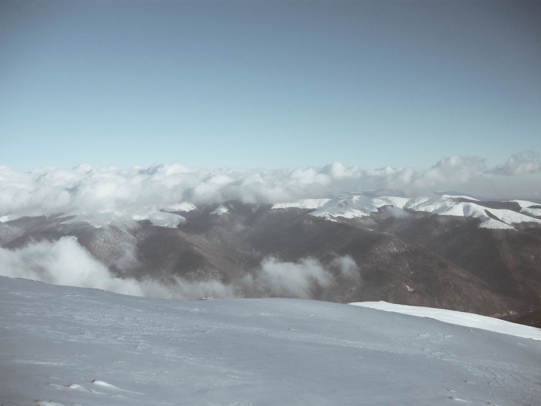 Snow-Covered Mountain Peaks with Cloudy Sky - Free Images, Stock Photos and Pictures on Pikwizard.com