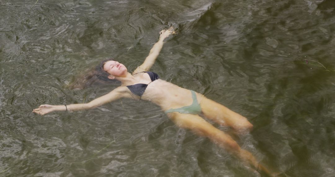 Woman Floating in Natural Water Relaxing and Enjoying Swimming - Free Images, Stock Photos and Pictures on Pikwizard.com