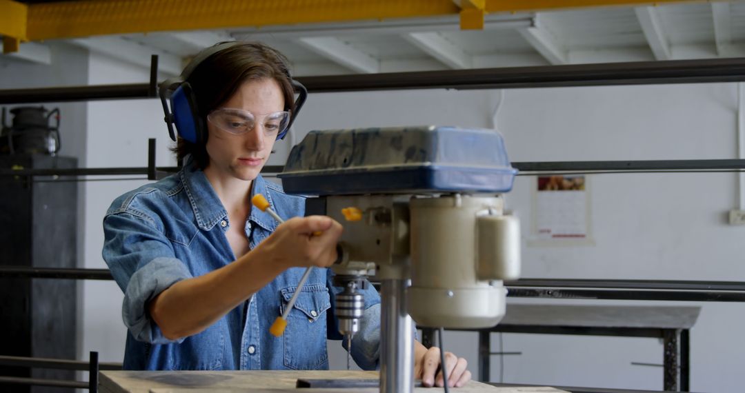 Young Woman Using Industrial Drill Press in Workshop - Free Images, Stock Photos and Pictures on Pikwizard.com