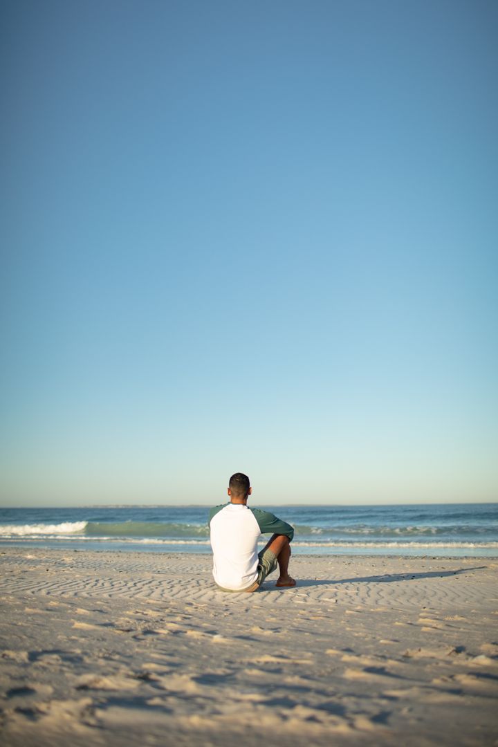 Man Relaxing on Beach with Clear Sky - Free Images, Stock Photos and Pictures on Pikwizard.com